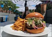  ?? COURTESY OF GRAND TOUR ?? Enjoy a lamb burger and steak frites out on the patio at Grand Tour on Newbury Street.