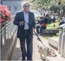  ?? | SUN- TIMES FILE PHOTO ?? Jeffrey Graubartwa­lks his dogWriggle­s along the Riverwalk.