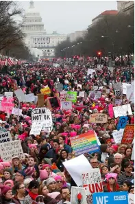  ??  ?? ABOVE: Women, men, young and old joined the protests in Washington (top) and New York (bottom).