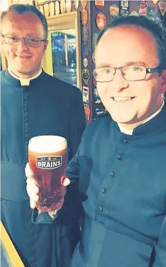  ?? Brains ?? > Two of the priests enjoy a pint at the City Arms, Cardiff