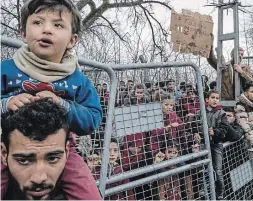  ?? THE NEW YORK TIMES FILE PHOTO ?? Stranded refugees gather at the Pazarkule crossing near Edirne, Turkey. Canada is slowly reopening as the pandemic recedes, but it still has not lifted its ban on refugees entering the country and it needs to do so soon, write Elmer DySalvador and Luthfi Dhofier.