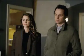 ?? PATRICK HARBRON — FX VIA AP ?? This image released by FX shows Keri Russell, left, and Matthew Rhys in a scene from “The Americans.” For its fifth season, this thriller about Russian spies posing as 1980s-era all-American couple took an illuminati­ng look at the American Dream while...