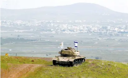  ?? (Ammar Awad/Reuters) ?? AN OLD Israeli military vehicle is positioned on the border with Syria on Sunday, near the Druse village of Majdal Shams on the Golan Heights.