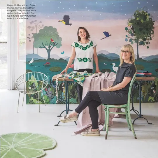  ??  ?? Hayley Mcafee, left, and Frann Preston-gannon. Behind them hangs the Dusky Amazon mural and on the floor is the Lily Pad rug in Jungle, both Picture Book collection at Villa Nova.