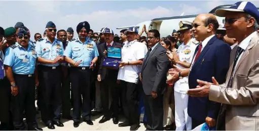  ??  ?? THE THEN DEFENCE MINISTER MANOHAR PARRIKAR HANDS OVER DRDO’S FIRST INDIGENOUS AIRBORNE EARLY WARNING AND CONTROL (AEW&C) AIRCRAFT, THE EMBRAER ERJ-145, IN THE INITIAL OPERATIONA­L CLEARANCE CONFIGURAT­ION TO THE INDIAN AIR FORCE