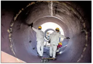  ?? Bloomberg News/ASIM HAFEEZ ?? Chinese welders work on the Engro Powergen Thar Ltd. power plant at a coal mine in Pakistan’s Thar desert in March. The project is one of several energy developmen­ts China is helping Pakistan build.