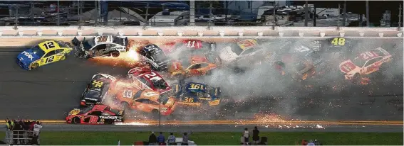  ?? Brian Lawdermilk / Getty Images ?? Twenty-one cars were involved in this pile-up after a restart with less than 10 laps to go in Sunday’s Daytona 500. It was one of five wrecks in the final 20 laps.