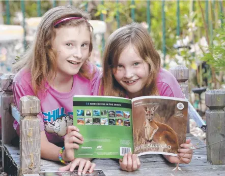  ??  ?? Sandor sisters Sofia, 9, and Alicia, 7, enjoy a sneak peek of the Great Australian Wildlife Book Collection which is launching in tomorrow’s Sunday Tasmanian. Picture: Jamie Hanson