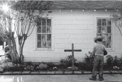  ??  ?? Case Leal, 8, of La Vernia looks at stones with names of victims outside First Baptist Church of Sutherland Springs in May.