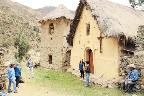  ?? PHOTOS: FRITZ FAERBER/ THE ASSOCIATED PRESS ?? Tourists admire a colonial-era church in Peru en route from Patacancha to Ollantayta­mbo, the gateway for those heading to Machu Picchu.