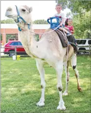  ?? Westside Eagle Observer/RANDY MOLL ?? Lee Allen and Valentina Sanchez, both 4, share a camel ride at Gentry’s annual Freedom Festival on Thursday.