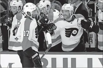  ?? [JEFFREY T. BARNES/THE ASSOCIATED PRESS] ?? Philadelph­ia’s Wayne Simmonds, left, is congratula­ted by Claude Giroux after a goal during Saturday’s game against Buffalo.