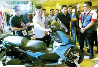  ?? (Malacañang photo) ?? AN EYE FOR MOTORCYCLE­S – President Duterte views the motorcycle­s on display during the annual national convention of the National Federation of Motorcycle Clubs of the Philippine­s at the Iloilo Convention Center in Iloilo City last Saturday. With the President is his former special assistant, Bong Go.