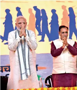  ?? (Photo by SAM PANTHAKY / AFP) ?? Indian Prime Minister Narendra Modi (L) addresses thousands of head of villages during an event marking the 150th birth anniversar­y of Indian independen­ce icon Mahatma Gandhi in Ahmedabad on October 2, 2019.