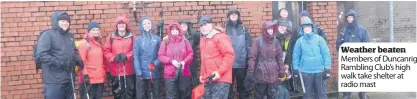  ??  ?? Weather beaten Members of Duncanrig Rambling Club’s high walk take shelter at radio mast