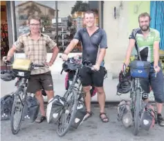  ??  ?? Clement (left), Matthew (centre) and William (right) during their stop at Keningau town yesterday before continuing their journey to Nabawan.