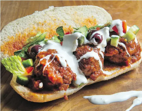  ?? PETER J THOMPSON / NATIONAL POST ?? Bonnie Stern’s Super Bowl Meatball Sandwich with Greek Salad.