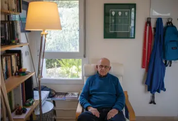  ?? Associated Press ?? ■ Holocaust survivor Maurice Gluck, poses for a photo Jan. 17 in his home in Ya'ad, northern Israel. Shortly before they were rounded up by Nazi troops in Belgium and deported to Auschwitz in 1942, the parents of 3-year-old Gluck placed their only child in the care of a local Christian family. Gluck forgot his Yiddish mother tongue and that he even had parents of his own.