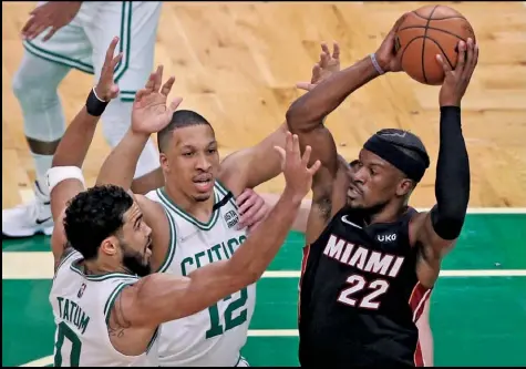  ?? Tribune News Service ?? Miami Heat forward Jimmy Butler (22) looks to pass as Boston Celtics forward Jayson Tatum (0) and forward Grant
Williams (12) defend in Game 4 of the Eastern Conference Finals at Td Garden in Boston on Monday, May 23, 2022.