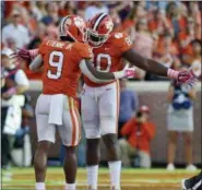  ?? RICHARD SHIRO — THE ASSOCIATED PRESS ?? Clemson’s Travis Etienne (9) celebrates with Milan Richard after scoring a touchdown during the second half of an NCAA college football game against North Carolina State, Saturday in Clemson, S.C.