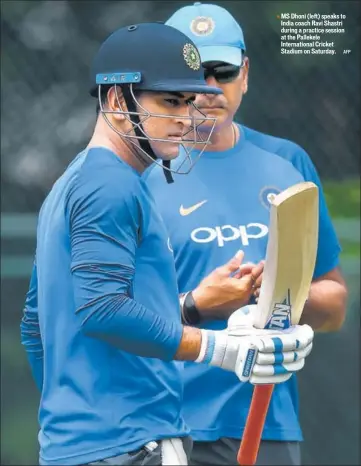  ?? AFP ?? MS Dhoni (left) speaks to India coach Ravi Shastri during a practice session at the Pallekele Internatio­nal Cricket Stadium on Saturday.