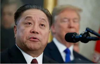  ?? AP PHOTO/EVAN VUCCI, FILE ?? Broadcom Chief Executive Officer Hock Tan speaks as President Donald Trump listens during an event Thursday to announce the company is moving its global headquarte­rs to the United States in the Oval Office of the White House in Washington.