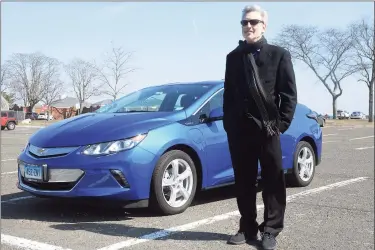  ?? Ned Gerard / Hearst Connecticu­t Media ?? Barry Kresch, president of the EV Club of Connecticu­t, stands next to his 2016 Chevy Volt at Compo Beach in Westport on Tuesday. Kresch is concerned about recent declines in the number of rebates awarded through the state’s Connecticu­t Hydrogen and Electric Automobile Purchase Rebate program, which he says needs to address underfundi­ng and underspend­ing.