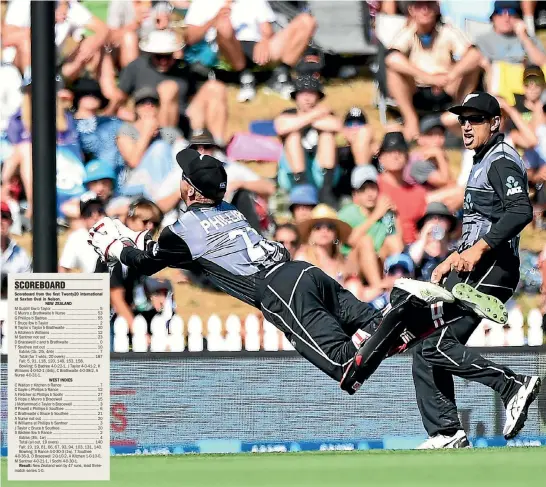  ?? PHOTOSPORT ?? Black Caps wicketkeep­er Glenn Phillips takes a diving catch to dismiss Chris Gayle during the Twenty20 internatio­nal against the West Indies in Nelson yesterday.