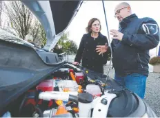  ?? JASON PAYNE ?? Automotive service technician Manoli Paterakis shows Energy Minister Michelle Mungall an electric motor after Mungall announced the creation of the EV Maintenanc­e Training program at BCIT.