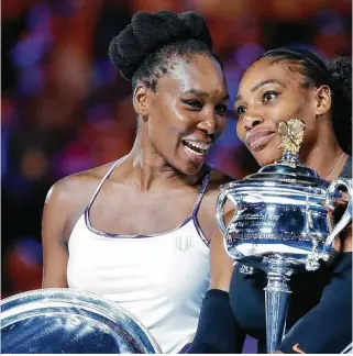  ??  ?? Serena Williams, right, and sister Venus exchange friendly banter after Serena won the Au Australian Open women’s singles title. The sisters made for the oldest Grand Slam women’s final in the Open era, combining for 71 years, 11 months.