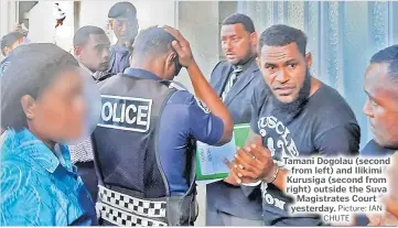  ?? Picture: IAN CHUTE ?? Tamani Dogolau (second from left) and Ilikimi Kurusiga (second from right) outside the Suva Magistrate­s Court yesterday.