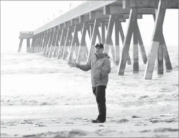  ?? Brian Gomsak
AP I mages f or t he Weather Channel ?? THE WEATHER CHANNEL’S new show will take place in a casual clubhouse atmosphere with a few bar stools and easy chairs. Above, the Weather Channel’s Jim Cantore at a North Carolina beach in May.