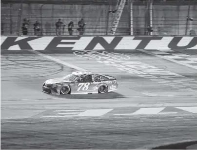  ?? ASSOCIATED PRESS FILE PHOTO ?? Martin Truex Jr. crosses the finish line to win the NASCAR Cup Series race on July 14 at Kentucky Speedway in Sparta, Ky. Sparse crowds and declining viewership have some drivers campaignin­g for change.