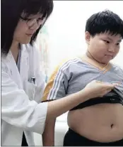  ?? PICTURE: BOBBY YIP / REUTERS ?? WEIGHING IN: Nine-year-old Wong Min-hin weighs 49kg at 1.38m. Obesity is becoming an ever-bigger problem in developed countries.