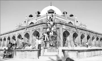  ??  ?? Master craftsmen used temporary ramps to lift material required for the conservati­on works. — AKTC Delhi photo