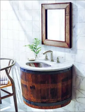  ??  ?? This wall-mount vanity from Native Trails is crafted from a reclaimed wine barrel. The company specialize­s in artisan-made products that team warmth and style.
