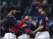  ?? RON SCHWANE — THE ASSOCIATED PRESS ?? Indians starter Carlos Carrasco celebrates with Yan Gomes after pitching a three-hitter against the Tigers on April 11 at Progressiv­e Field.