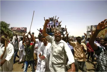  ??  ?? Sudanese protesters gather near the military headquarte­rs in the capital Khartoum. — AFP photo