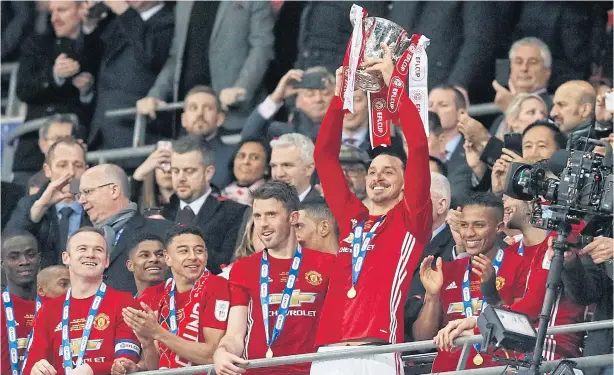  ?? AP ?? Manchester United’s Zlatan Ibrahimovi­c lifts the League Cup trophy after his team beat Southampto­n in the final at Wembley on Sunday.