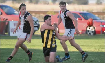  ??  ?? PASS: Pimpinio’s Nathan Sachse gets the ball away from his Edenhope-apsley opponents.