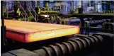  ?? KEVIN FAINGNAERT/ NEW YORK TIMES ?? Steel slabs are cut to length last month at ArcelorMit­tal’s plant in Zelzate, Belgium.