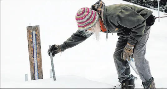  ?? Brittany Peterson The Associated Press ?? Billy Barr measures the depth of new snow that has fallen onto a board on March 13 in Gothic, Colo. So-called “citizen scientists” like Barr have long played important roles in gathering data to help researcher­s better understand the environmen­t.