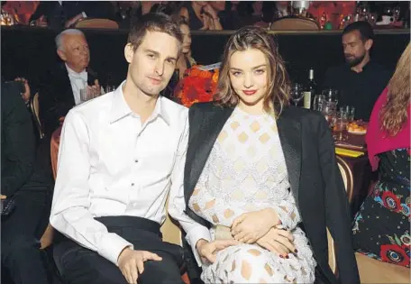  ?? Michael Kovac WireImage ?? SNAP CEO Evan Spiegel with supermodel fiancee Miranda Kerr at the Beverly Hilton in 2016. He has largely stayed out of the public eye.