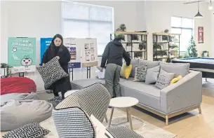  ??  ?? LEFT Employees tidy up a communal recreation room at the Port Apartment project.