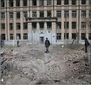  ?? EVGENIY MALOLETKA — THE ASSOCIATED PRESS ?? A woman looks on a crater of an explosion after a Russian airstrike in Kostyantyn­ivka, Donetsk region, Ukraine, on Saturday.