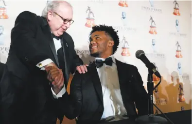  ?? LM Otero / Associated Press ?? Heisman Trophy winner Kyler Murray shakes hands with David O’Brien Jr. on Monday after receiving the Davey O’Brien Award as college football’s best quarterbac­k. Murray has to return $1.29 million of the $1.5 million the A’s paid him last year.