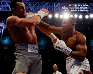 ?? Photo: ACTION IMAGES/ANDREW COULDRIDGE ?? PUTTING ON A SHOW: Joshua [right] and Klitschko thrill the fans at Wembley