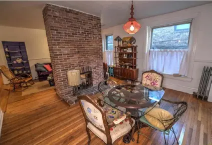  ?? Caiolinn Ertel ?? The dining room in the condominiu­m at 813 S. Braddock Ave. is separated from the living room by a twosided fireplace.