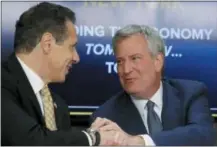  ?? AP PHOTO/BEBETO MATTHEWS, FILE ?? New York Gov. Andrew Cuomo, left, and New York City Mayor Bill de Blasio shake hands Nov. 18, 2018, during a news conference in New York. Cuomo and de Blasio trumpeted Amazon’s decision to build a $2.5 billion campus in the Queens borough of New York as a major coup.