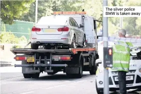  ??  ?? The silver police BMW is taken away